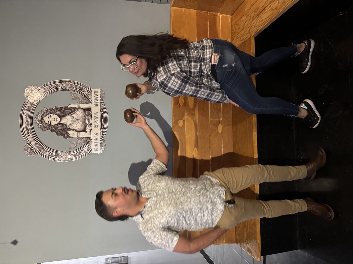 Founders holding kava shells under Gaia's logo