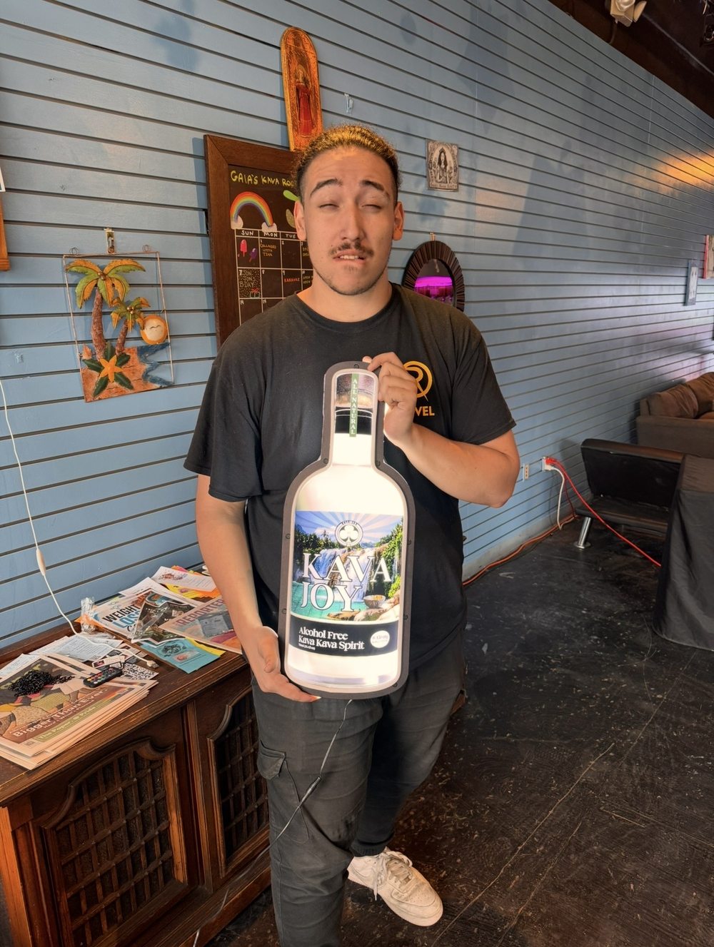 Jonjon with Kava Joy sign at Gaia's